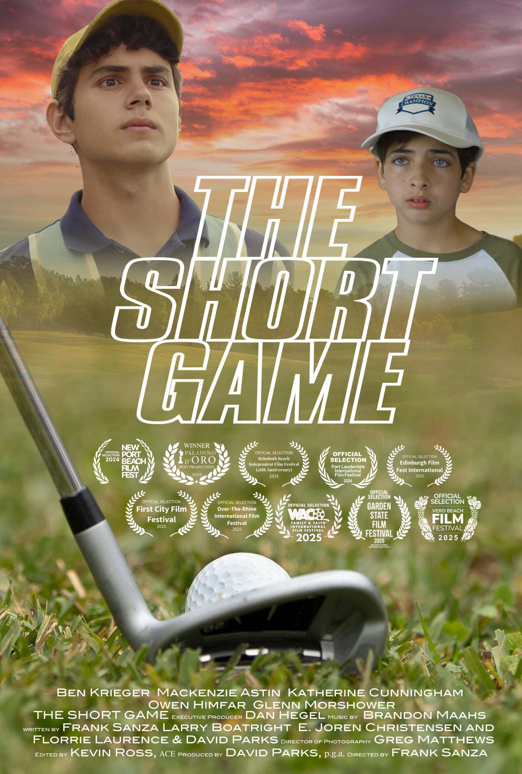 A young boy with a golf club and golf ball on a lush course at sunset.