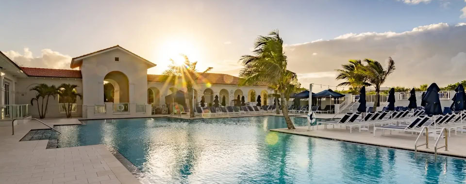 Vero Beach Film Festival outdoor pool area with lounge chairs and palm trees.